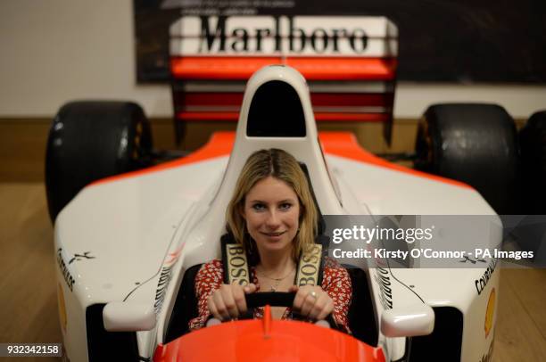 Bonhams employee sits in the 1993 McLaren-Ford MP4/8A Formula 1 racer, driven to victory by legendary racing driver Ayrton Senna in his final Monaco...