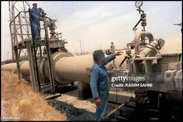 Two Iraqi oil technicians checking puming equipment at Kirkuk oil pump station minutes after the start of oil pumping to Turek's yumurtalik port on...