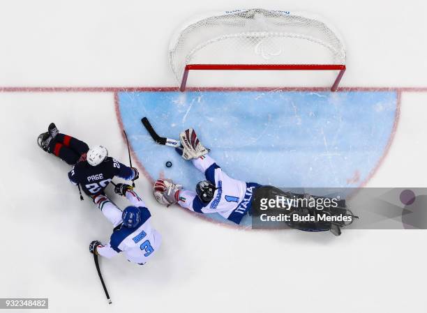 Adam Page of the United States battles for the puck with a goalkeeper Santino Stillitano of Italy in the Ice Hockey semifinals game between United...