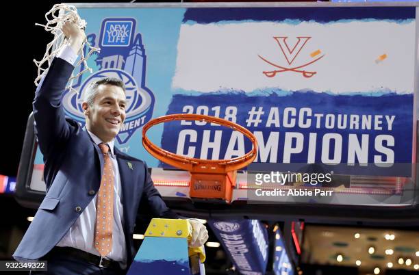 Head coach Tony Bennett of the Virginia Cavaliers cuts down the net after defeating the North Carolina Tar Heels 71-63 during the championship game...