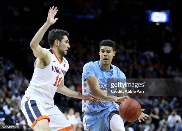 Cameron Johnson of the North Carolina Tar Heels works against Ty Jerome of the Virginia Cavaliers in the first half against the Virginia Cavaliers...
