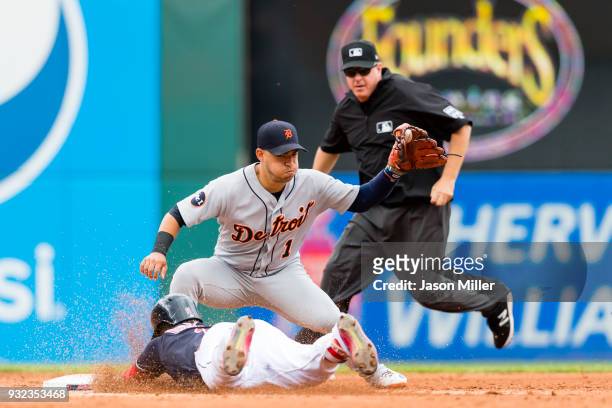 Second base umpire Paul Emmel watches as shortstop Jose Iglesias of the Detroit Tigers waits for the throw as Jose Ramirez of the Cleveland Indians...