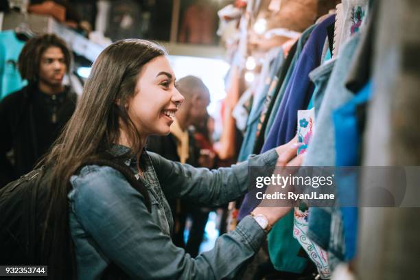 young adults shop for clothes at thrift store - generation z shopping stock pictures, royalty-free photos & images