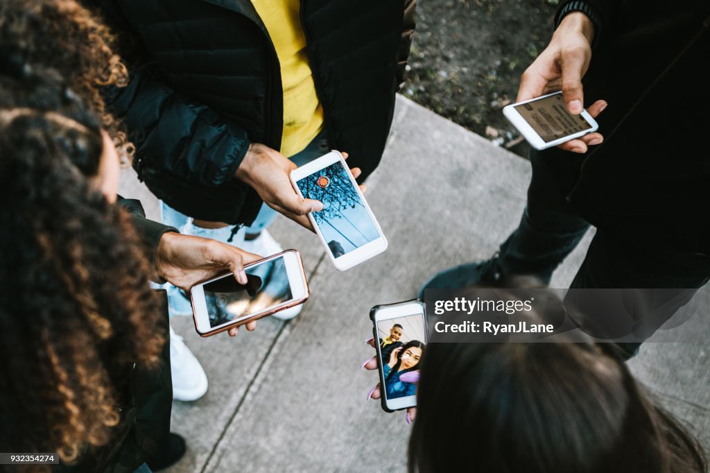 Group of Young Adults Looking at Phone