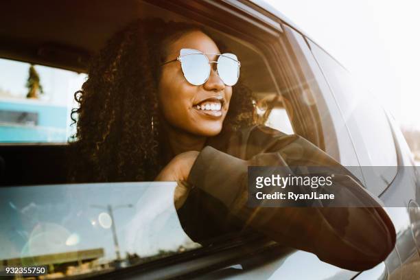 group of young adults having fun riding in car - driving stock pictures, royalty-free photos & images