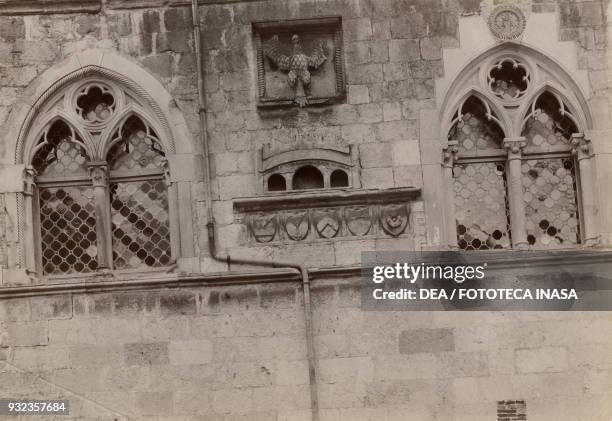 Gothic windows on the facade of the Town hall, Venzone, Friuli-Venezia Giulia, Italy, photograph from Istituto Italiano d'Arti Grafiche, Bergamo,...