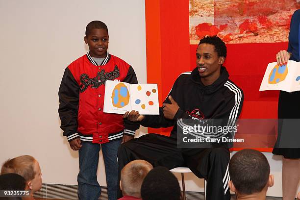 Brandon Jennings of the Milwaukee Bucks reads to students during the Read to Achieve event sponsored by the Bucks and the Sam's Hope Literacy...