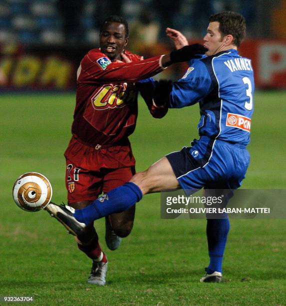 Bastia's defender, Gregory Vanney , vies with Lens's forward John Utaka, during their French league cup football match, 21 December 2004 at the...