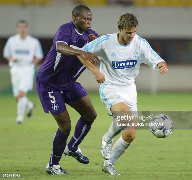 Olympique de Marseille forward Russian Dimitri Sytchev is challenged by Austria Vienna defender Rabiu Afoladi , during the first Champions league...