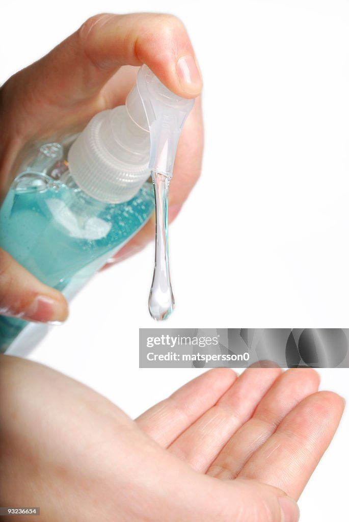 Woman applying hand sanitizer or soap