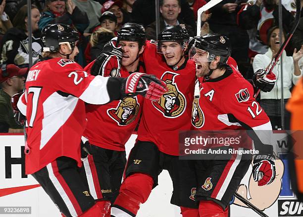 Matt Carkner of the Ottawa Senators celebrates his first period goal against the Pittsburgh Penguins with teammates Alexei Kovalev, Alexandre Picard...