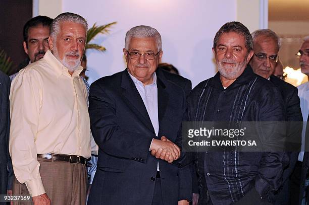 Palestinian President Mahmoud Abbas shakes hands with Brazilian President Luiz Inacio Lula da Silva , next to Bahia State's Governor Jacques Wagner...