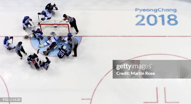 Joshua Misiewicz#24 of United States scores over Gabriele Araudo, goaltender of Italy in the Ice Hockey semi final game between United States and...