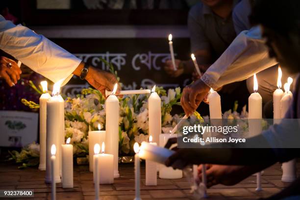 People attend a candlelight vigil for the victims of the US-Bangla plane crash on March 15, 2018 in Dhaka, Bangladesh. At least 50 people were killed...