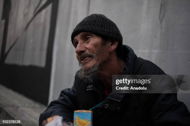 Homeless man Nacho breaks down as he listens to some music while drinking some juice from the garbage can on a sidewalk across the street in Bogota,...