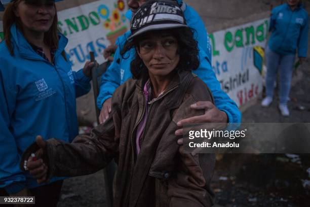 Homeless woman receives help and a hug from the Blue Angels in Bogota, Colombia on March 14, 2018. Blue Angels are the ones who walk in the streets...