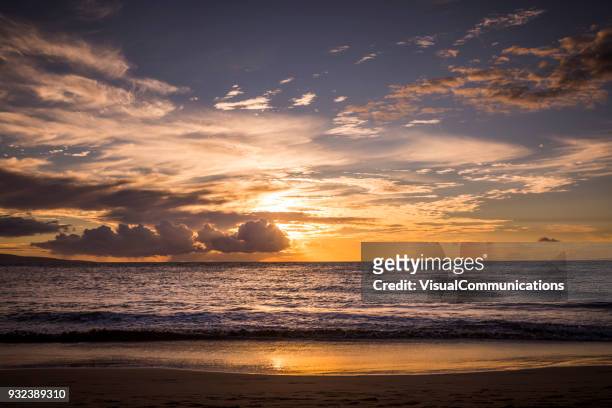 tropical sunset on beach in maui. - sunset beach hawaii stock pictures, royalty-free photos & images