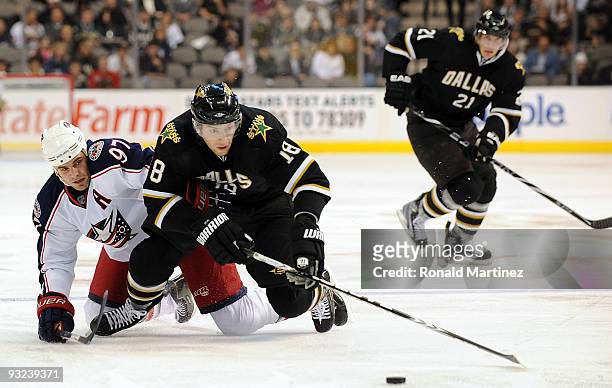 Left wing James Neal of the Dallas Stars is tripped by Rostislav Klesla of the Columbus Blue Jackets in the first period on November 19, 2009 in...