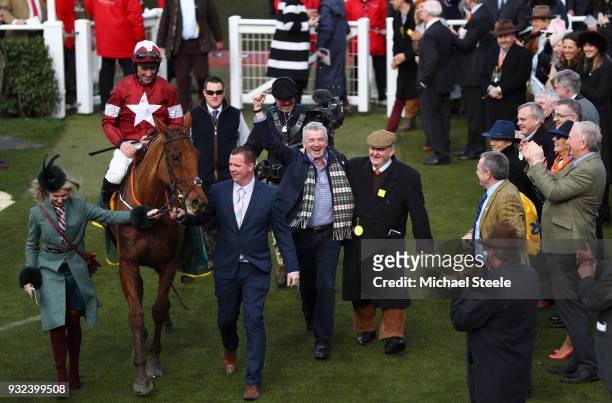 Balko Des Flos ridden by Davy Russell is lead in the the winners enclosure by Michael O'Leary after victory in the Ryanair Chase at Cheltenham...