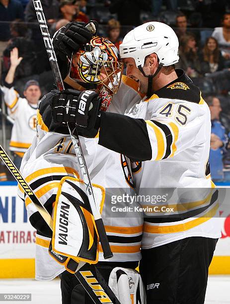 Mark Stuart congratulates goaltender Tuukka Rask of the Boston Bruins after the Bruins 4-3 win by shootout over the Atlanta Thrashers at Philips...