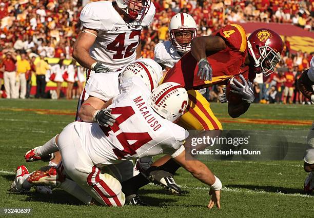 Running back Joe McKnight of the USC Trojans is tackled by linebacker Nick Macaluso of the Stanford Cardinal on November 14, 2009 at the Los Angeles...