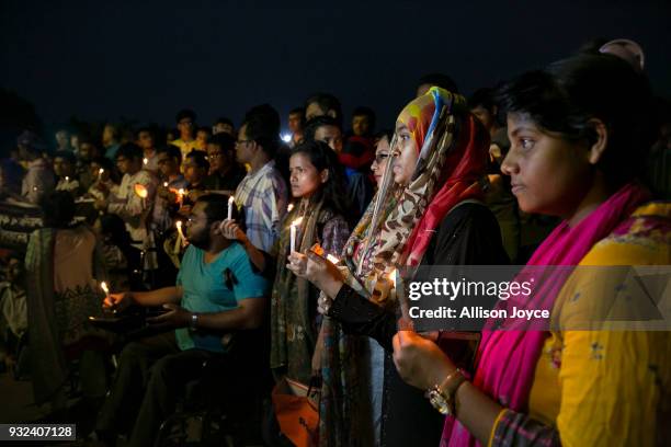 People attend a candlelight vigil for the victims of the US-Bangla plane crash on March 15, 2018 in Dhaka, Bangladesh. At least 50 people were killed...