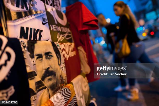 T-shirt for sale, depicting the drug lord Pablo Escobar, is seen arranged at the market stand on the street in Medellín, Colombia on December 02,...