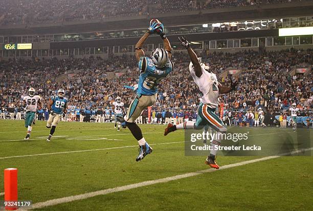 Steve Smith of the Carolina Panthers makes a 27 yard touchdown reception in the fourth quarter against Vontae Davis of the Miami Dolphins at Bank of...