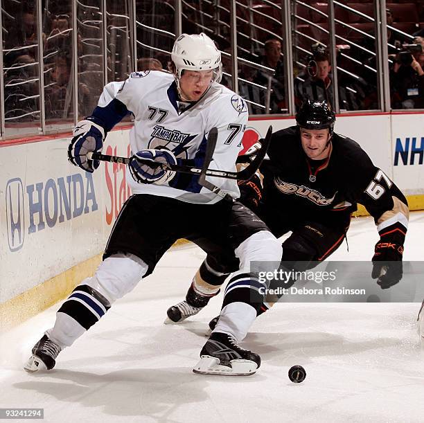 Victor Hedman of the Tampa Bay Lighting handles the puck behind the net against MacGregor Sharp of the Anaheim Ducks during the game on November 19,...