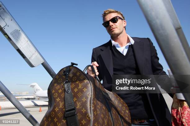 David Beckham of the Los Angeles Galaxy boards the team's charter flight to Seattle ahead of their MLS Cup game on Sunday against Real Salt Lake on...
