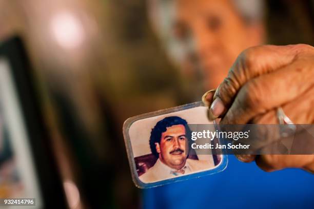 Rosalvina Vargas de Gallego, one of the first inhabitants of the Pablo Escobar neighborhood, shows a picture of Pablo Escobar kept in her wallet in...