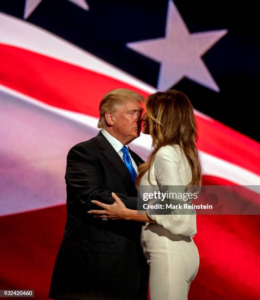 View of American real estate developer and presidential candidate Donald Trump and his wife, former model Melania Trump, onstage on first night of...