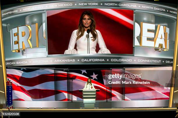 With a massive image projected above her, former model Melania Trump speaks from the podium on first night of Republican National Convention at...