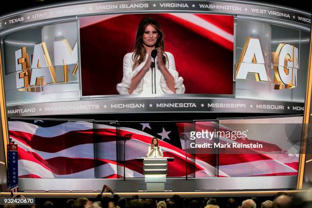With a massive image projected above her, former model Melania Trump speaks from the podium on first night of Republican National Convention at...