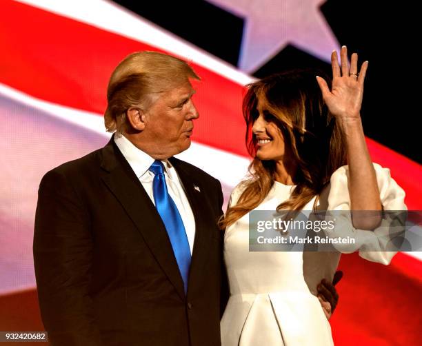 View of American real estate developer and presidential candidate Donald Trump and his wife, former model Melania Trump, onstage on first night of...