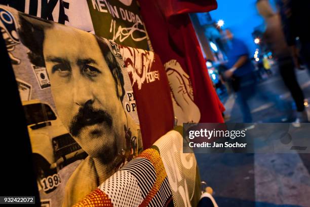 T-shirt for sale, depicting the drug lord Pablo Escobar, is seen arranged at the market stand on the street in Medellín, Colombia on December 02,...