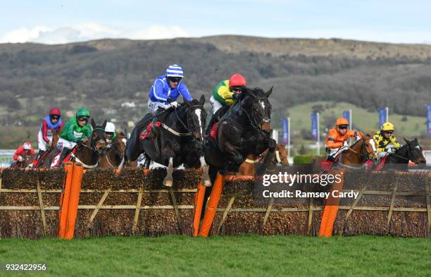 Cheltenham , United Kingdom - 15 March 2018; Penhill, left, with Paul Townend up, jumps the last alongside Supasundae, with Robbie Power up, who...