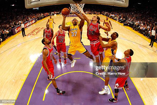 Ron Artest of the Los Angeles Lakers goes to the basket against Joakim Noah of the Chicago Bulls during the game on November 19, 2009 at Staples...