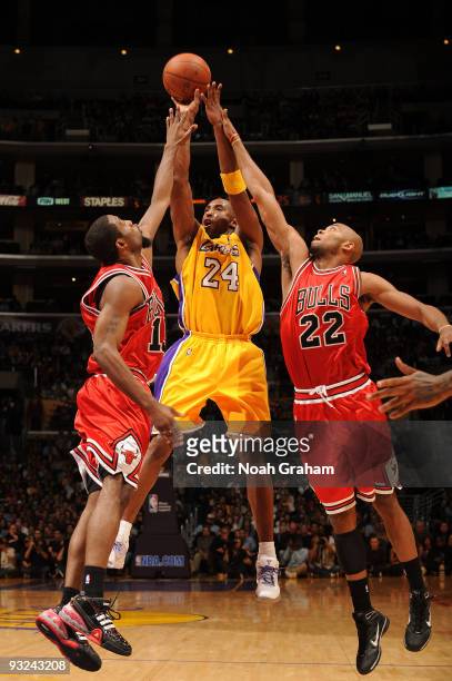 Kobe Bryant of the Los Angeles Lakers shoots between John Salmons and Taj Gibson of the Chicago Bulls at Staples Center on November 19, 2009 in Los...