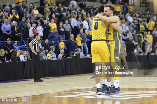 Marquette Golden Eagles guard Andrew Rowsey and Marquette Golden Eagles guard Markus Howard hug during a National Invitation Tournament game between...