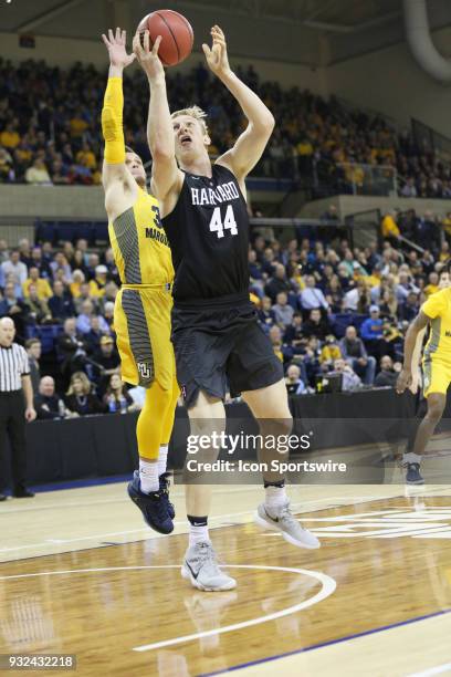 Harvard Crimson forward Henry Welsh shoots during a National Invitation Tournament game between the Marquette Golden Eagles and the Harvard Crimson...