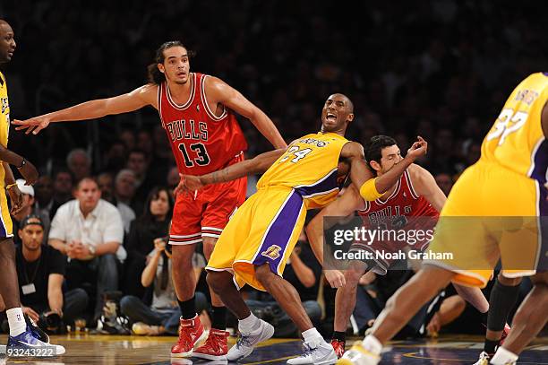Kobe Bryant of the Los Angeles Lakers fights for position against Joakim Noah and Kirk Hinrich of the Chicago Bulls at Staples Center on November 19,...