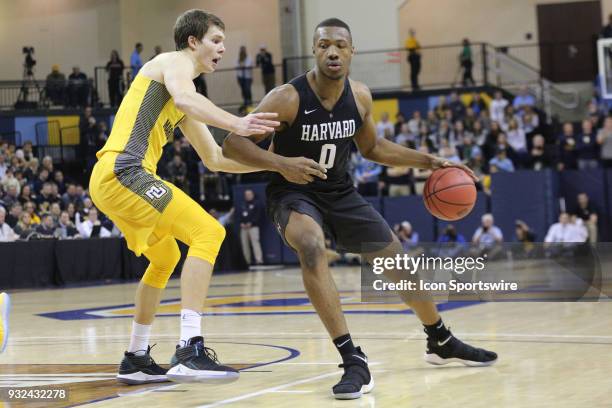 Harvard Crimson forward Chris Lewis drives during a National Invitation Tournament game between the Marquette Golden Eagles and the Harvard Crimson...