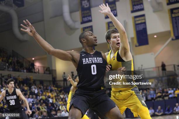 Marquette Golden Eagles center Matt Heldt and Harvard Crimson forward Chris Lewis battle for position during a National Invitation Tournament game...