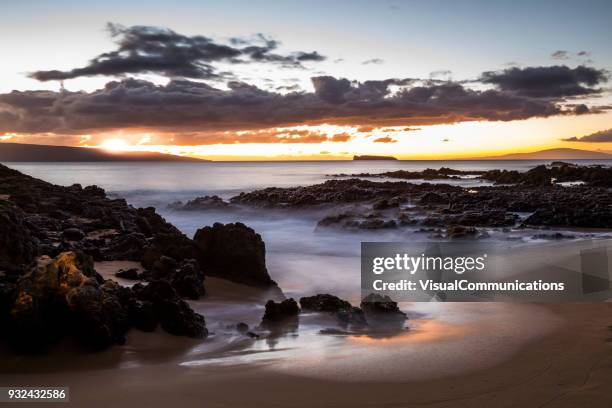 tropical sunset on makena beach in maui. - makena beach stock pictures, royalty-free photos & images