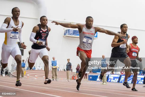 Elijah Hall of the University of Houston lunges toward the finish line placing 2nd in the Mens 60 Meter Dash with ; Jaylen Bacon of Arkansas State...