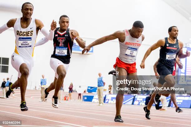 Elijah Hall of the University of Houston lunges toward the finish line placing 2nd in the Mens 60 Meter Dash with ; Jaylen Bacon of Arkansas State...