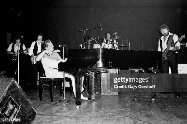 American Rock and Roll musician Jerry Lee Lewis plays piano as he leads his band during a performance onstage at the Ritz, New York, New York, August...