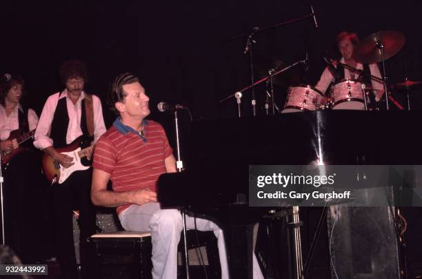 American rock 'n' roll icon Jerry Lee Lewis performs on stage at the Ritz, New York, New York, August 7, 1980. Among them is Kenny Lovelace on guitar.