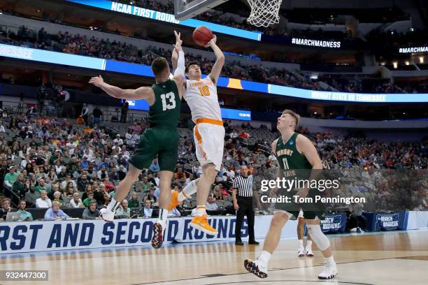 John Fulkerson of the Tennessee Volunteers goes up for a shot between Grant Benzinger and Loudon Love of the Wright State Raiders in the first half...